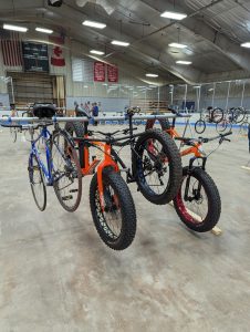 bicycles hanging on metal racks in ice skating rink
